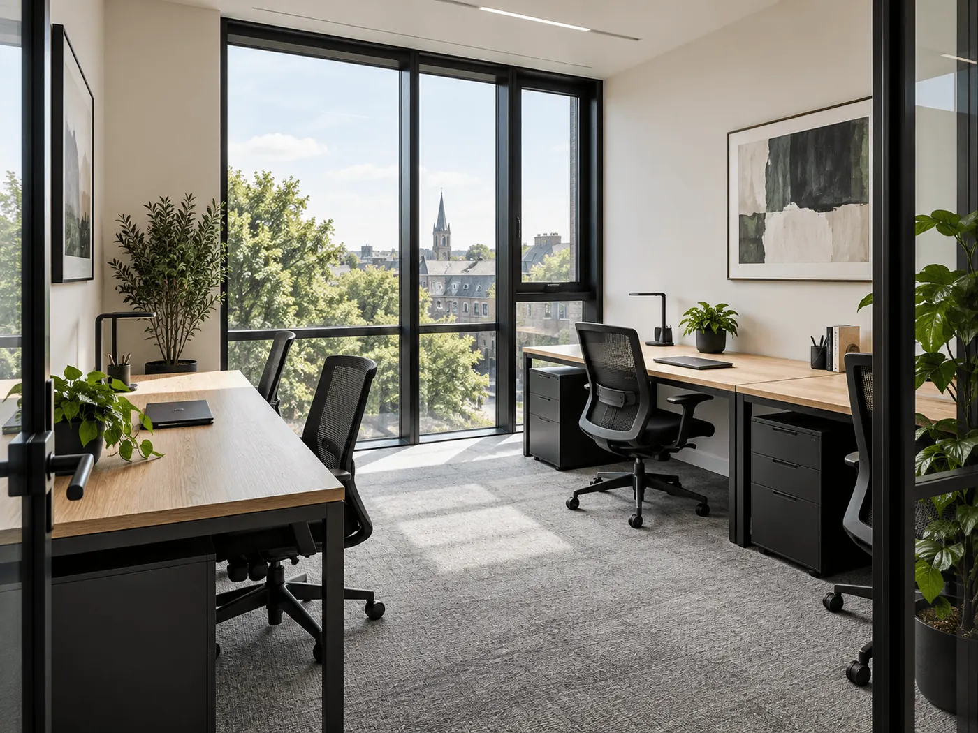 Private office with two desks and a large window onto city rooftops